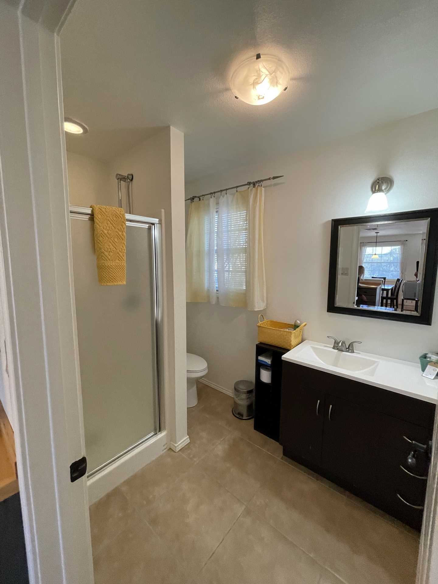                                                 A shower stall and fresh linens complete the full bath here, and it's a spotless place to clean up!