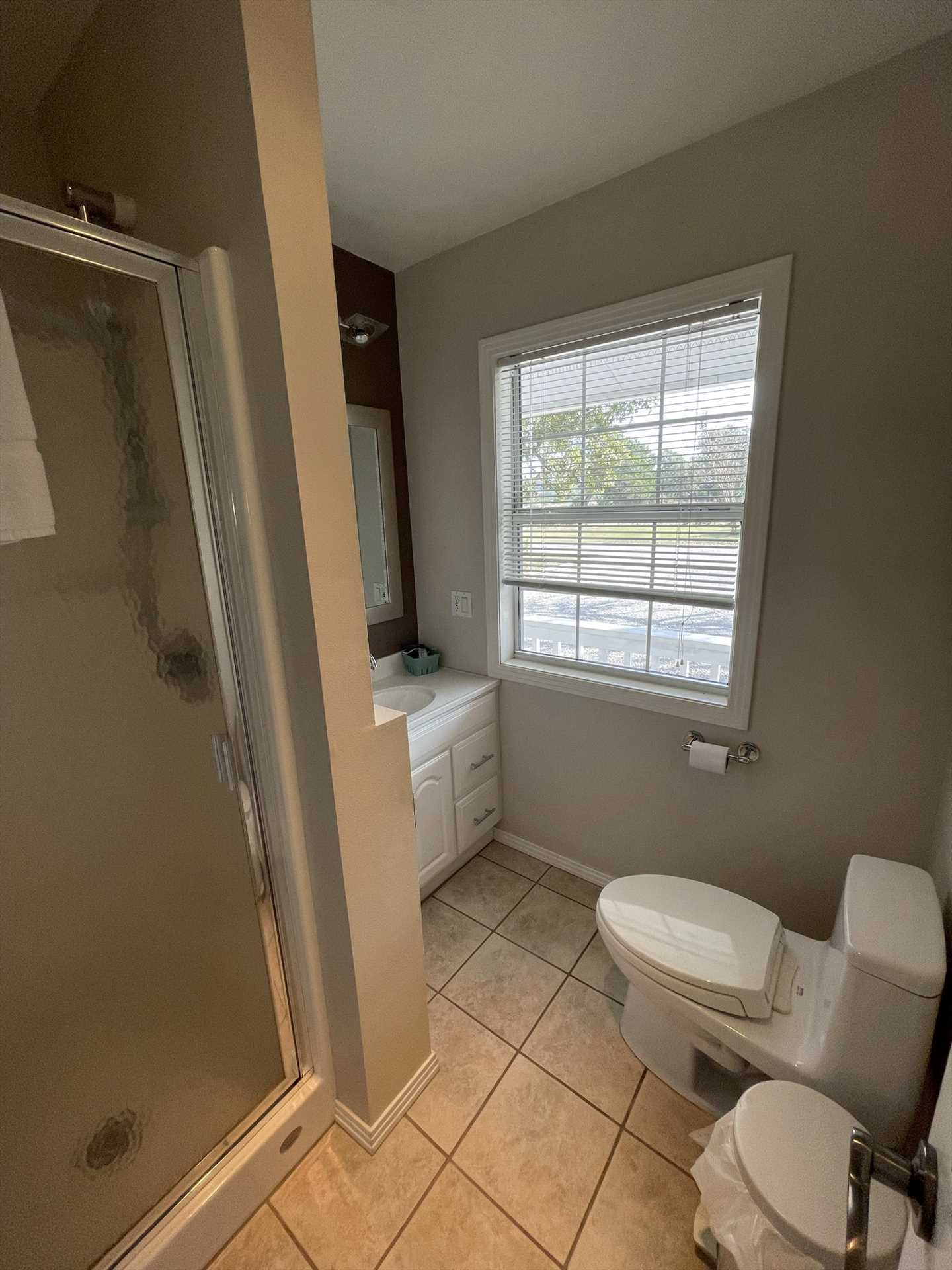                                                 The second full bath is immaculately clean, too, complete with a convenient vanity and shower.