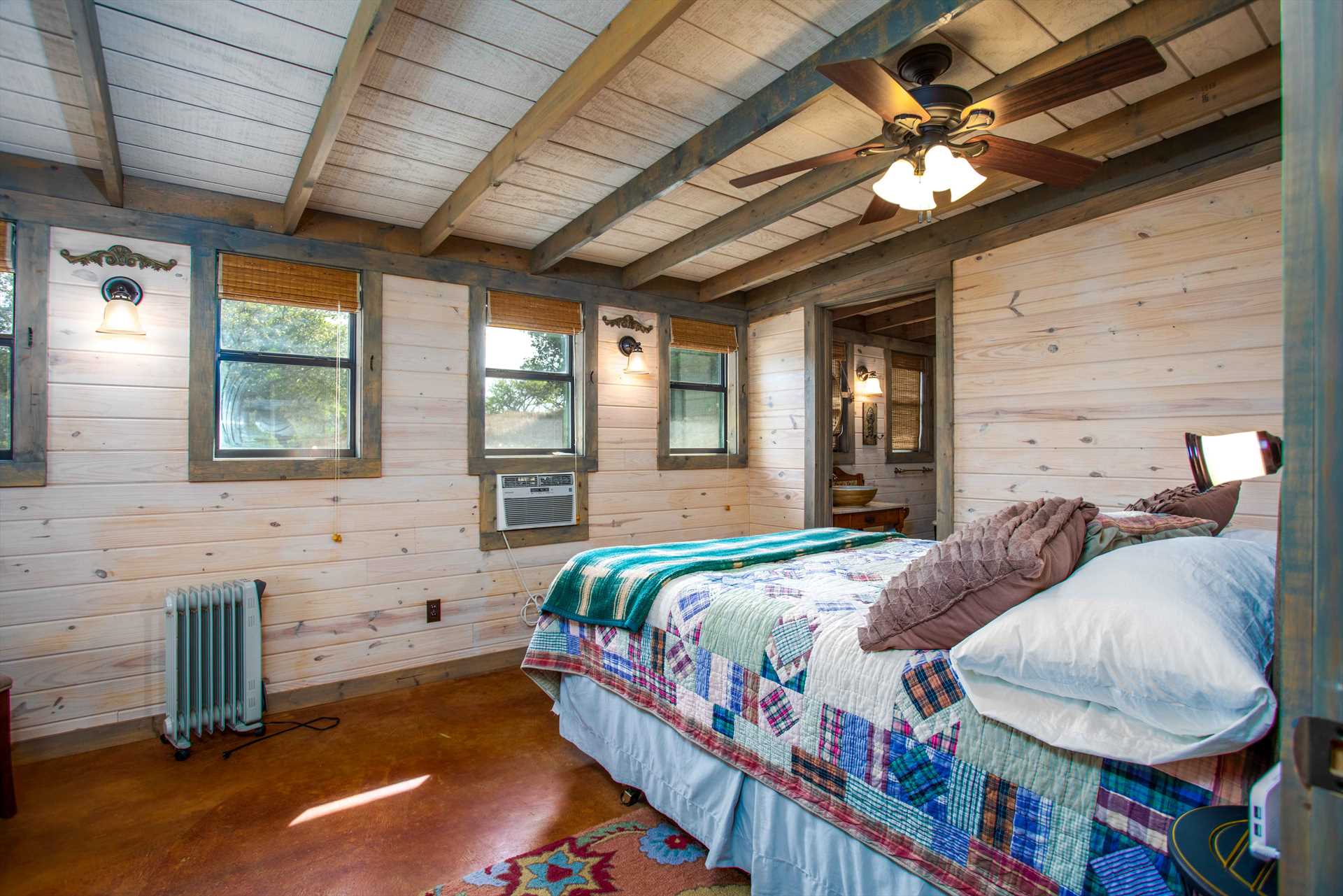                                                 Bright paneling and ceiling work accents the master bedroom, and it has a comfy queen-sized bed, too! All bed and bath linens are provided for your stay, as well.