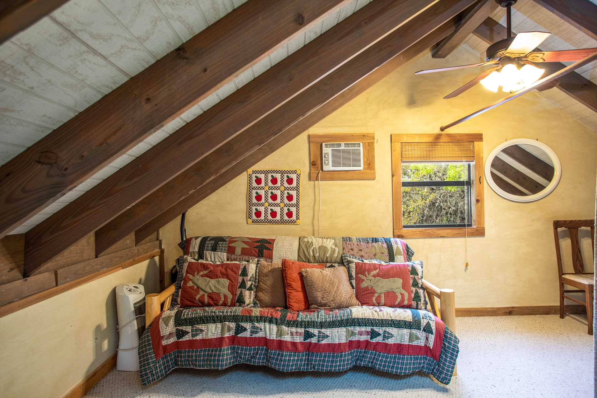                                                 Also up in the loft is a futon dressed in country flair-and it folds out to provide peaceful slumber for two.