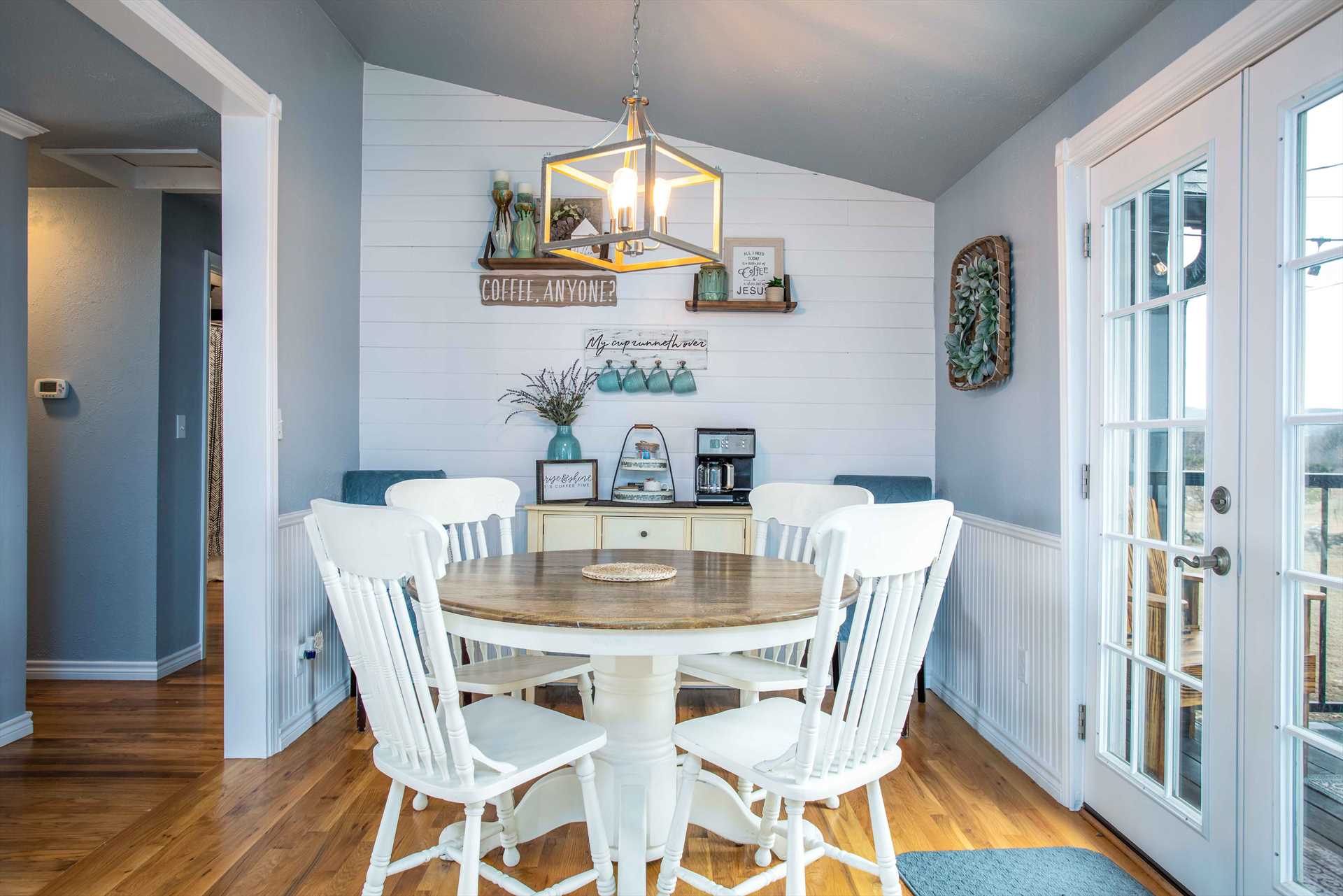                                                 Check out this charming breakfast nook, flooded with warm natural light through French doors!