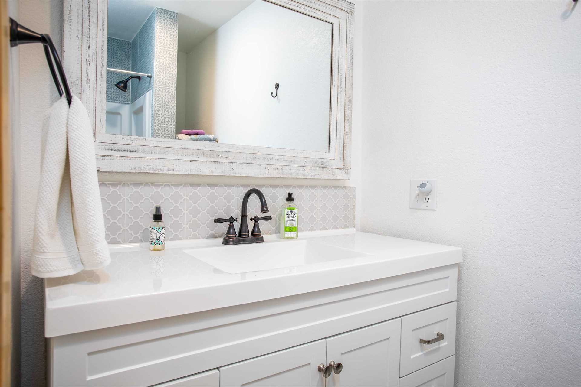                                                 A big, mirrored vanity with plenty of toiletry space graces the spotlessly-clean second bathroom!