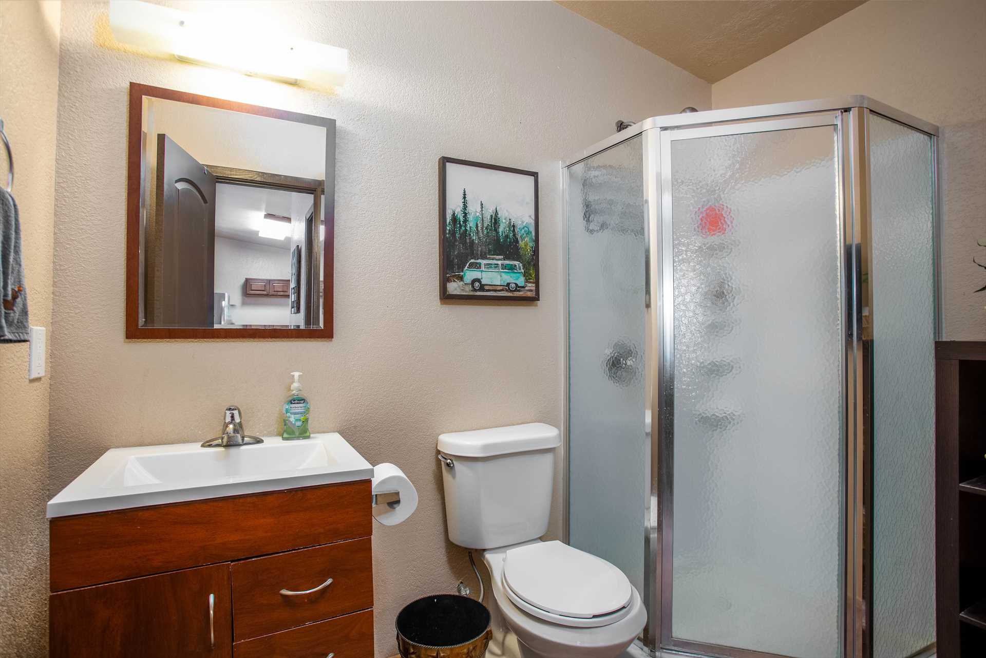                                                 The immaculate bath here features a roomy shower stall, and plenty of soft and fluffy linens for easy cleanup!
