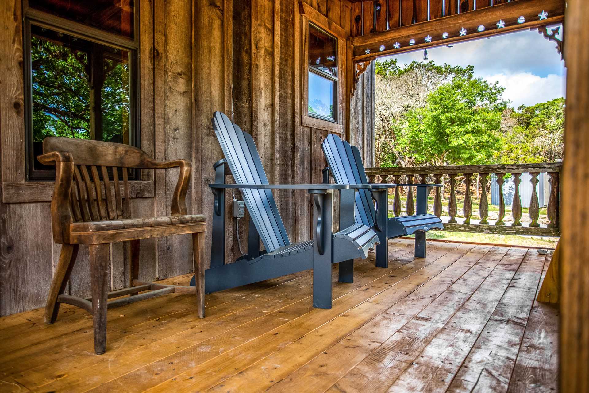                                                 Our guests love the shaded porch! While you're relaxing here, take a good look at the decorative star-and-globe filagreed woodwork.
