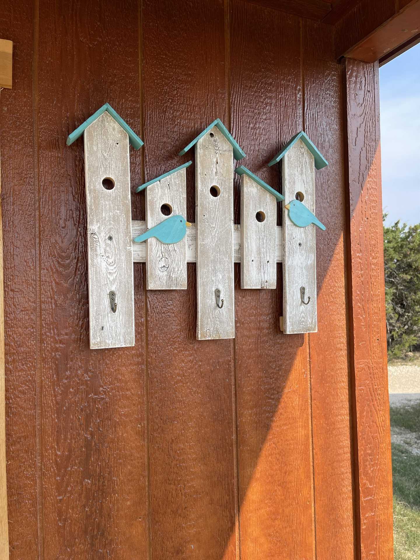                                                 The birdhouse motif by the door welcomes you home to your private nest in the Hill Country!