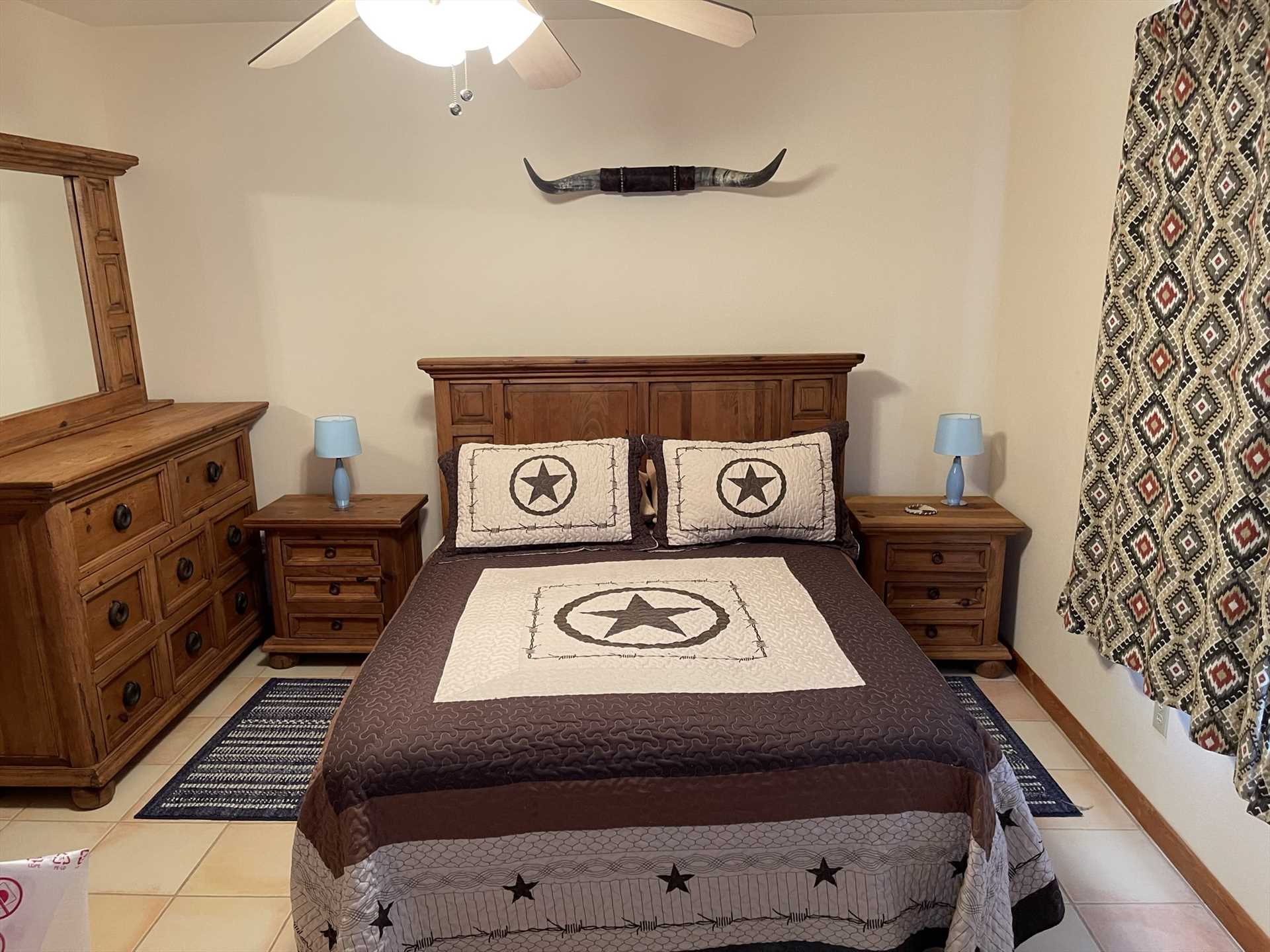                                                 Fresh and warm Lone Star linens cover the luxuriously comfortable queen-sized bed in the second bedroom!