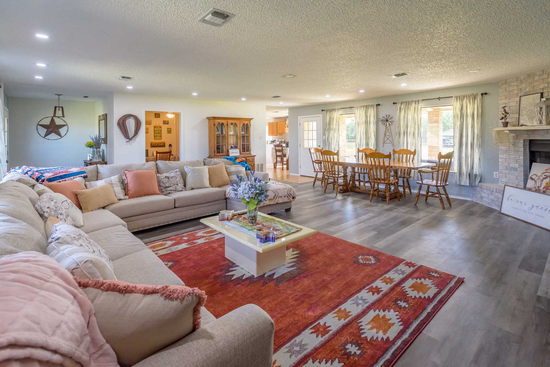                                                 The enormous sectional in the living area, along with a big and roomy dining area, provide plenty of seating in the heart of the wide-open floor plan.
