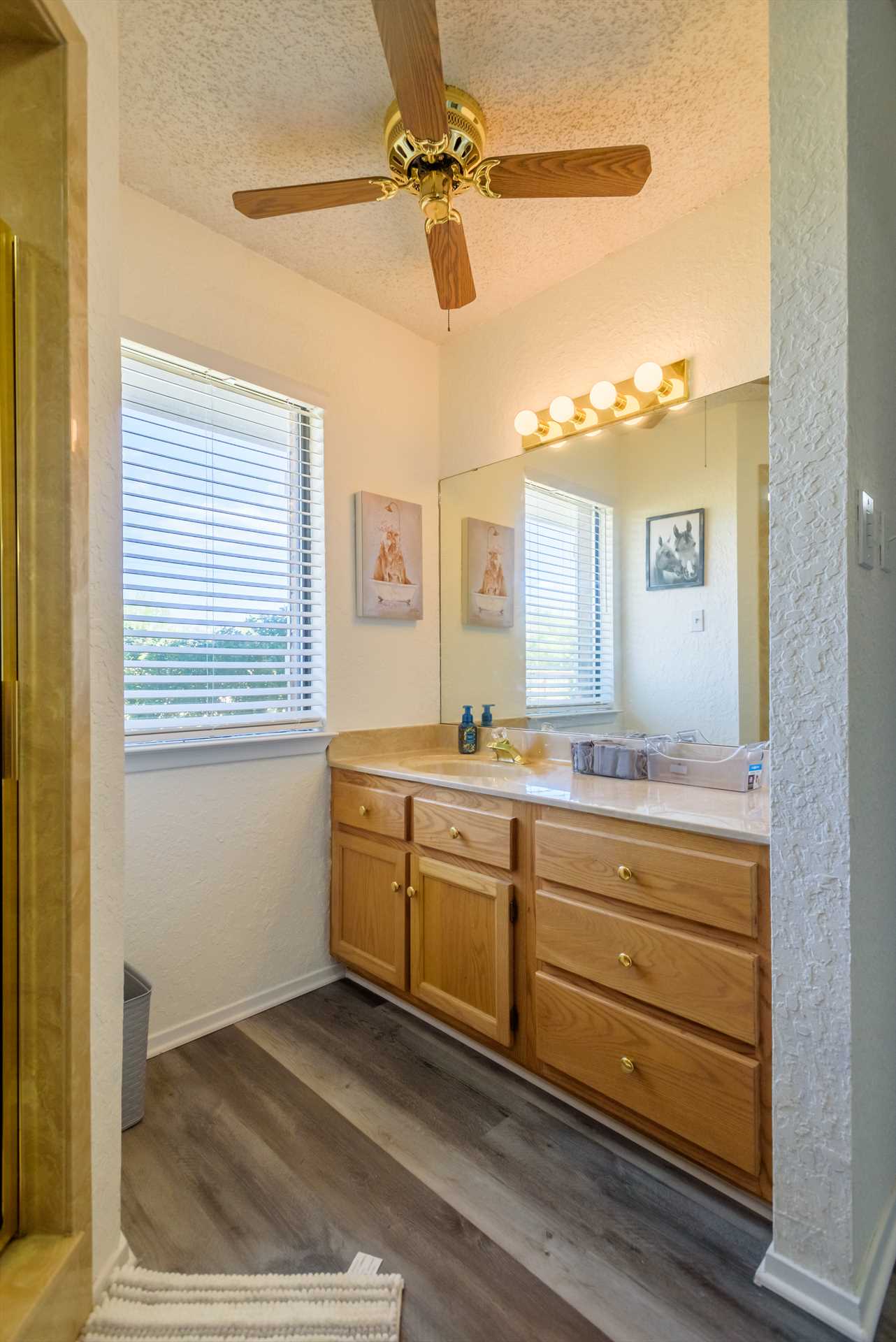                                                Shared between the second and third bedrooms, the second full bath features a single vanity and plenty of fresh linens.