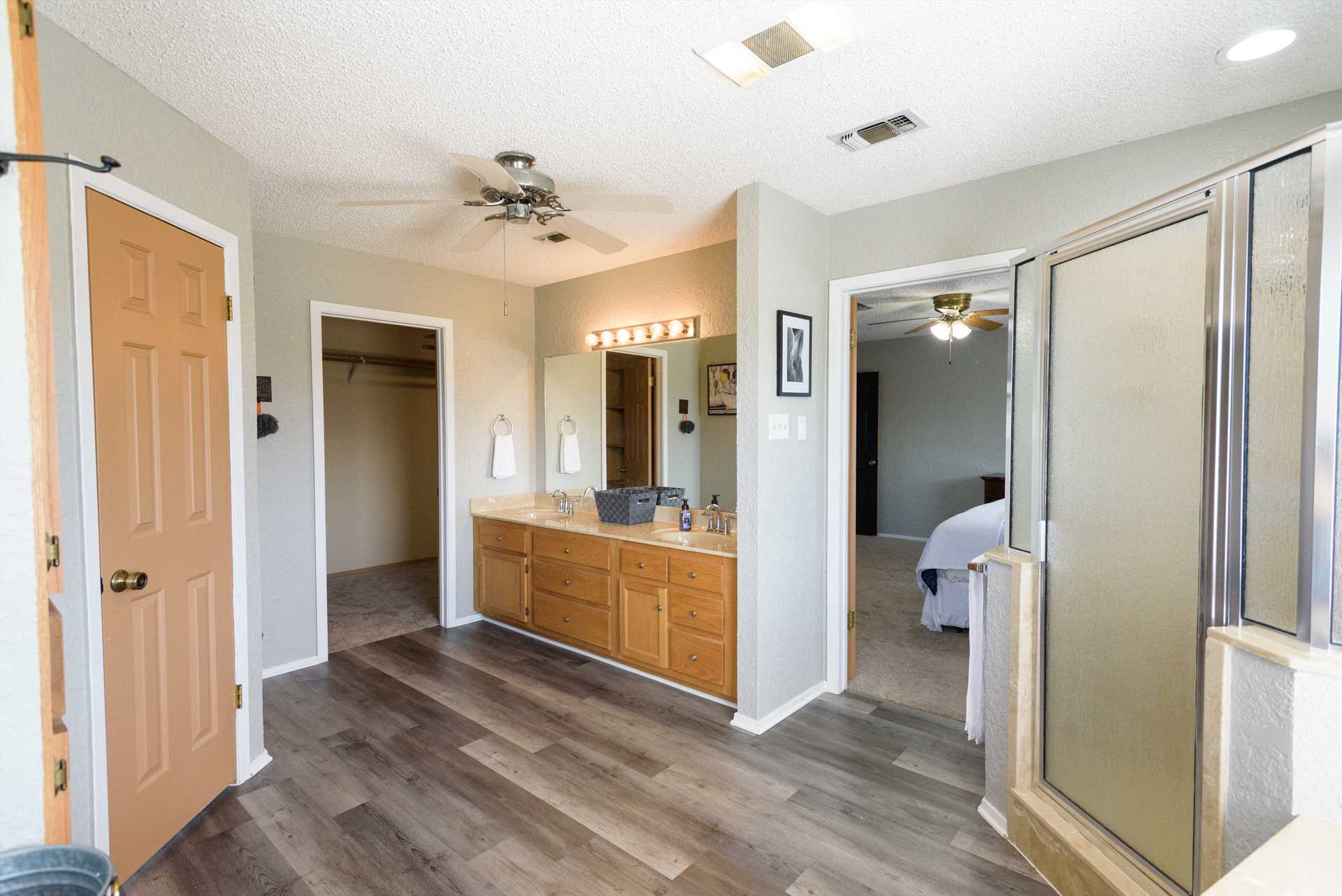                                                 Twin vanities and a great big shower stall make cleanup in the master bath a pleasure!